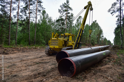 Pipelayer with side boom Installation of gas and crude oil pipes in ground. Construction of the gas pipes to new LNG plant.