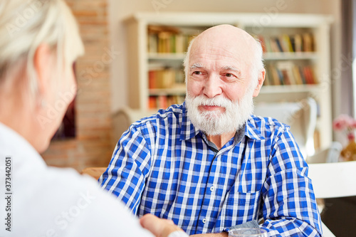 Senior man attentively listens to his doctor