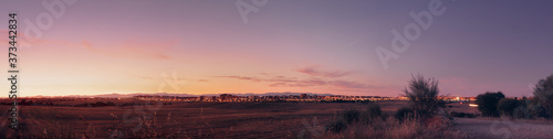  Sunset over the city lights panorama