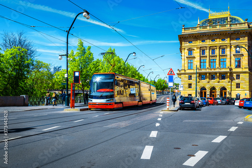Electric red tramway and cityscape with old buildings, Prague, Europe