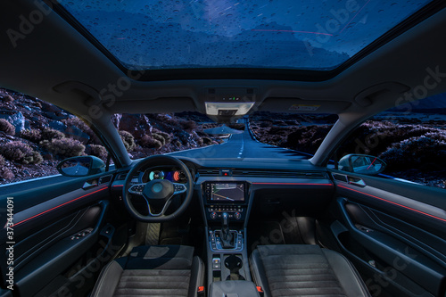  car is in autonomous driving mode with a panoramic glass roof while driving at night in the mountains © Mike Mareen