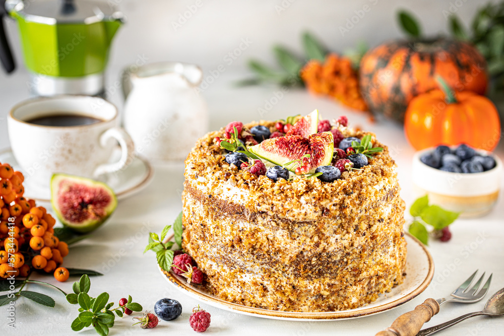Carrot cake decorated with berries and figs on a white plate. Traditional donkey pastries