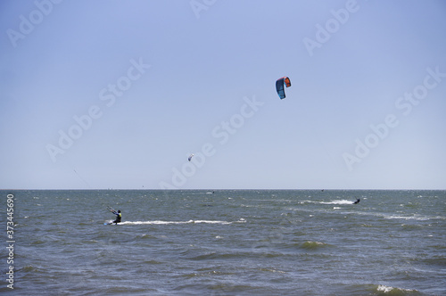 View of people kitesurfing at the beach