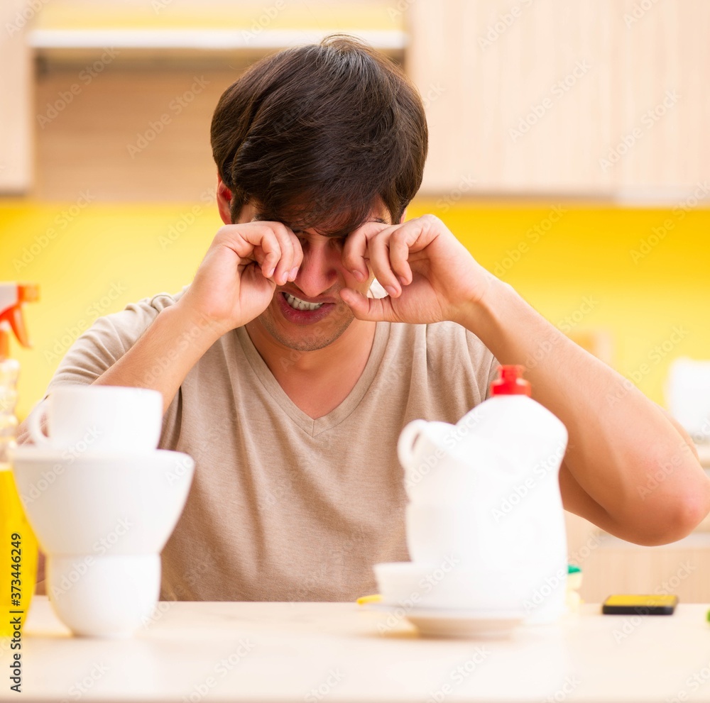 Man washing dishes at home