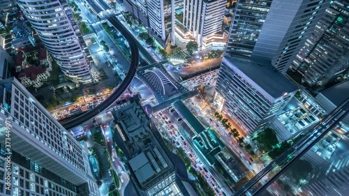 Time lapse Aerial view and top view of traffic on city streets in Bangkok , Thailand. Expressway with car lots. Beautiful roundabout road in the city center.