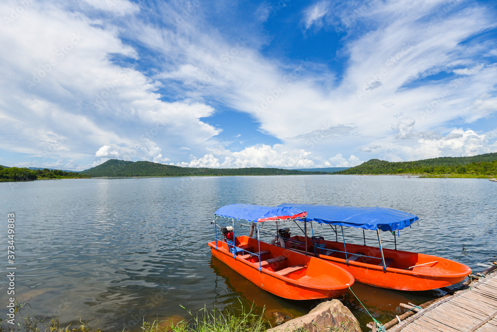 Small fisher boats at the harbour in iver water in thailand blue sky with clouds beautiful and island mountain background landscape - Plastic boat