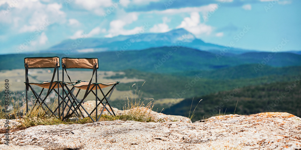 Adventure travel. Time to travel and travelling concept. Breathtaking mountains view. Tourist chair on top of mountain