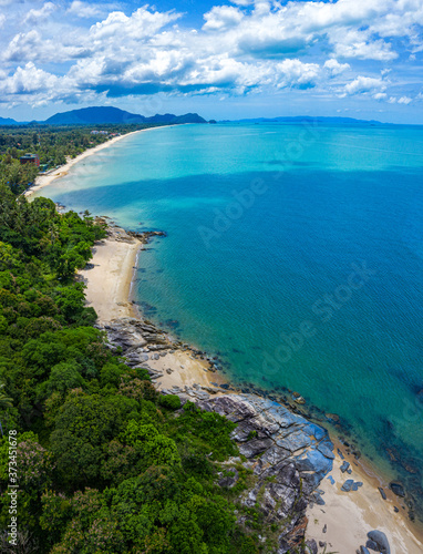 Aerial view image of sea, beache and jungle with blue sky in Nakhon Si Thammarat, Thailand