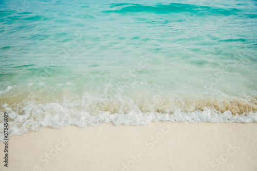  Blue sea ocean, water sun reflection, and sand background.