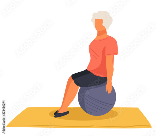 Senior woman exercising on fitball, pensioner training keeping fit