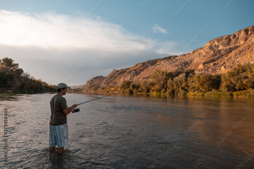 river fisherman with fishing rod