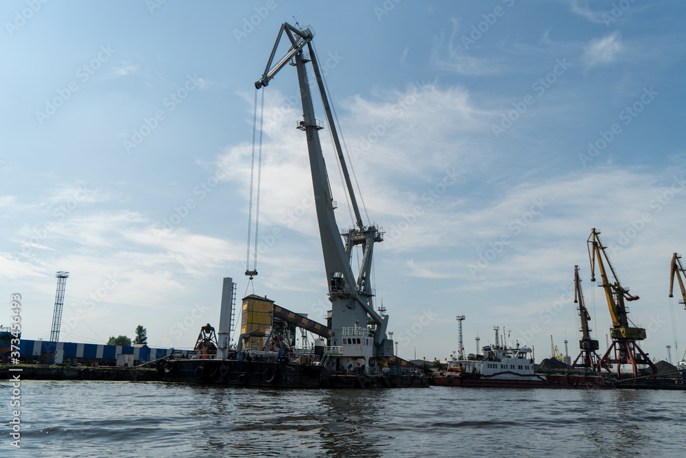 loading and unloading crane mounted on a small barge