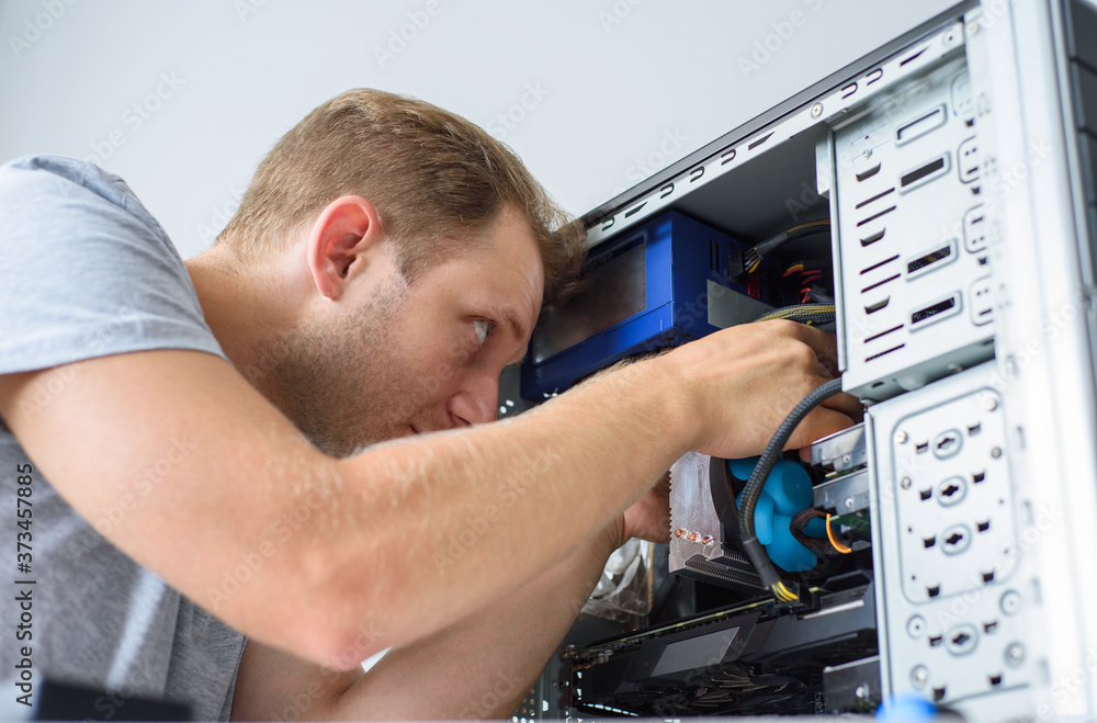 A man fixing a computer. Closeup A man fixing a computer. Closeup