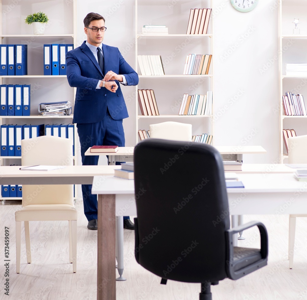 Young handsome businessman employee working in office at desk Young handsome businessman employee working in office at desk