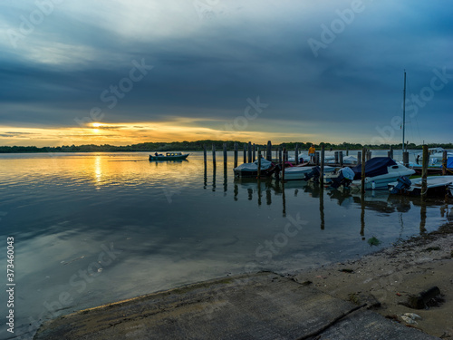 Lagoon landscape at dawn with fishermen boats