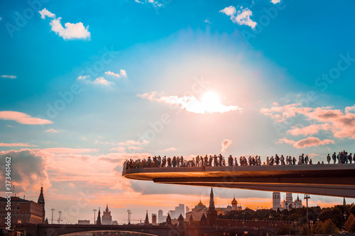 Floating bridge with people above Moskva River in Zaryadye Park, Moscow, Russia in summer in sunset
