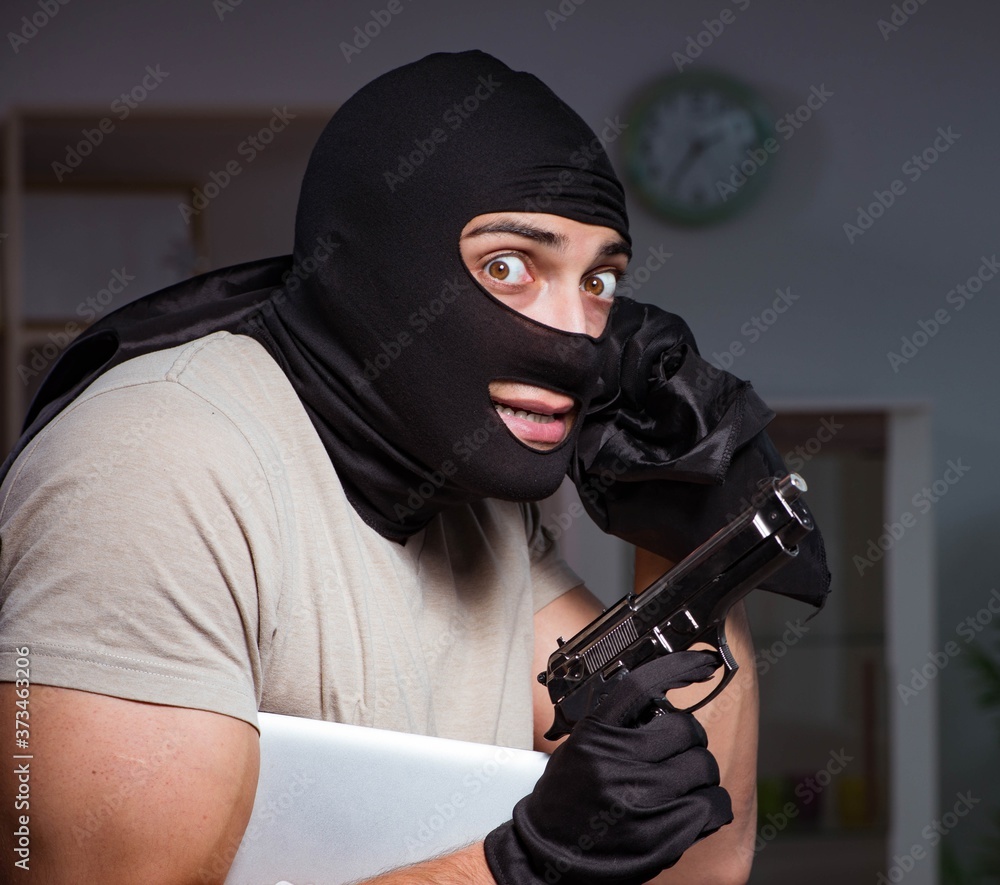 Burglar wearing balaclava mask at crime scene Burglar wearing balaclava mask at crime scene