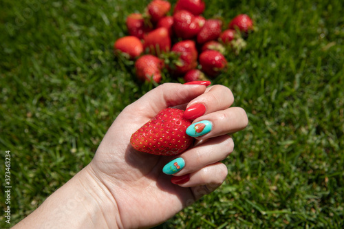 Fresh strawberries in the hands of a child