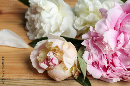 Beautiful fragrant peonies on wooden table, closeup © New Africa