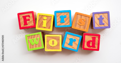 First word word made from colourful wooden baby development blocks