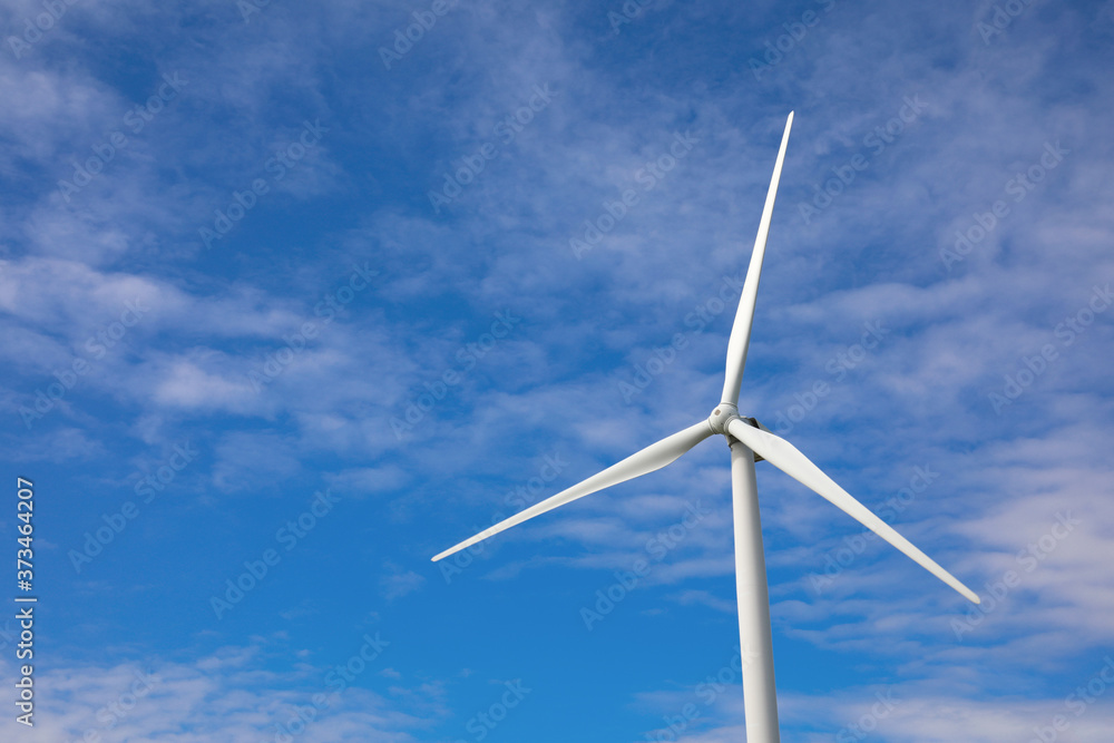 Wind turbine against beautiful blue sky. Alternative energy source Wind turbine against beautiful blue sky. Alternative energy source