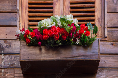 red roses bouquet in wooden box