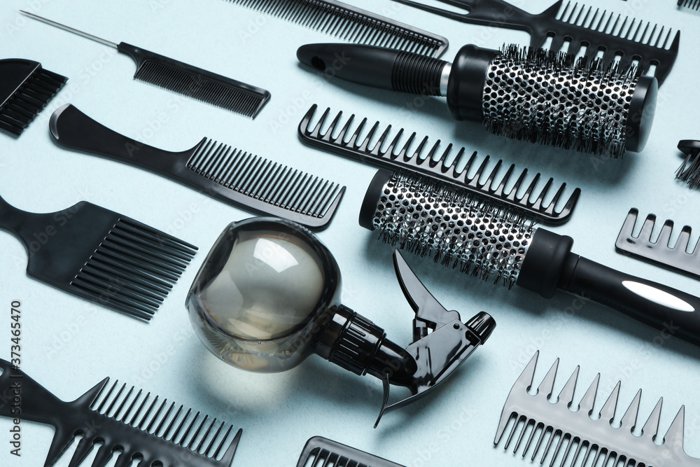 Composition with modern hair combs and brushes on light background Composition with modern hair combs and brushes on light background