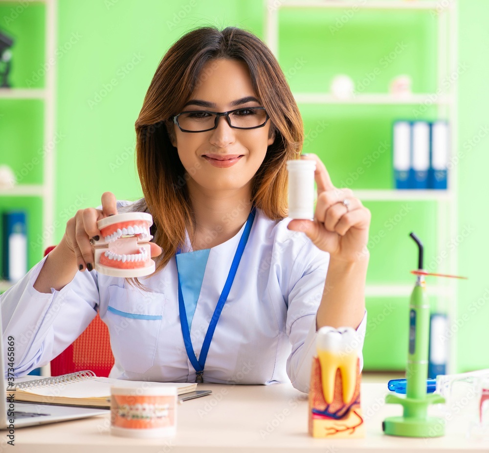 Woman dentist working on teeth implant Woman dentist working on teeth implant