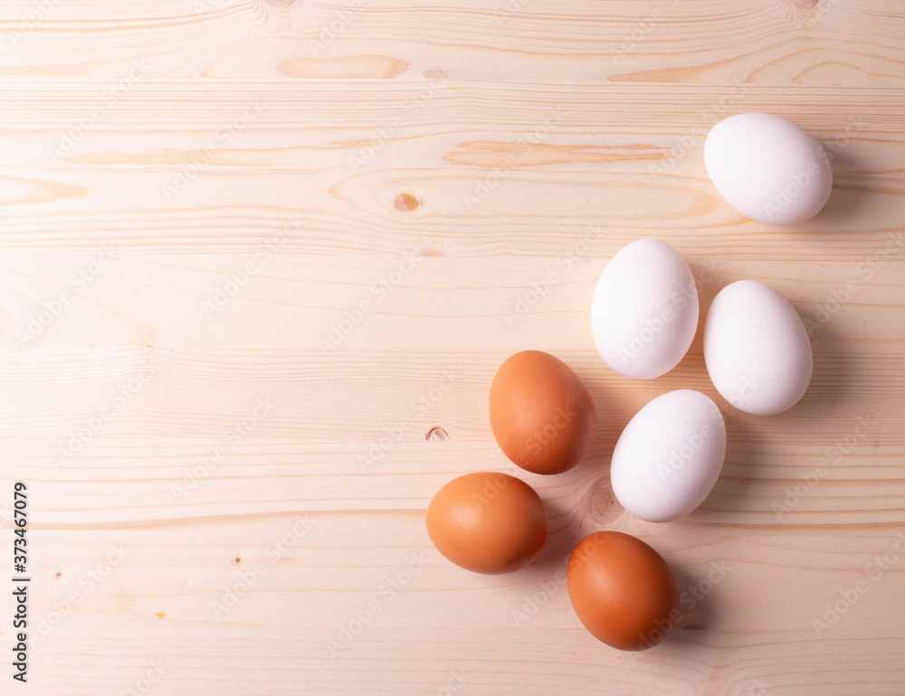 chicken raw eggs on the rustic wooden surface chicken raw eggs on the rustic wooden surface