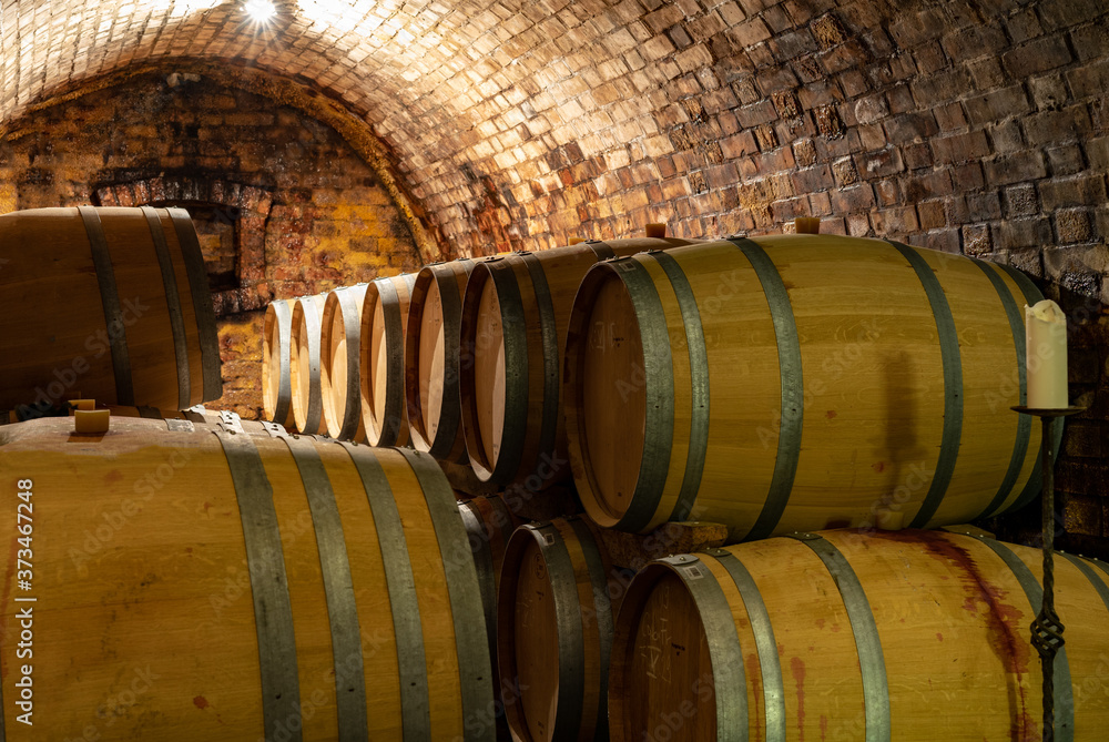 wooden old barrels in the rustic wine cellar with brick walls in villany hungary wooden old barrels in the rustic wine cellar with brick walls in villany hungary