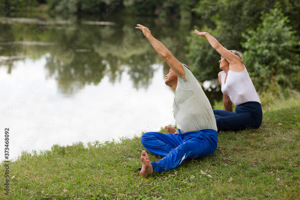 Senior family couple exercising and doing their stretches outdoors. healthy lifestyle. Social Distancing. copy space. Senior family couple exercising and doing their stretches outdoors. healthy lifestyle. Social Distancing. copy space.