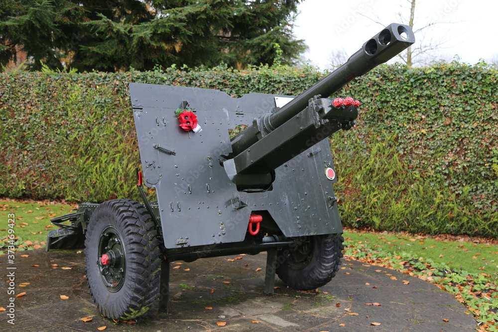 A 25 Pounder Gun in a park with red Remembrance Day poppies. A 25 Pounder Gun in a park with red Remembrance Day poppies.