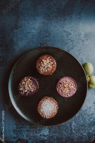 Wallpaper Mural Four different vegan cakes on the black plate. Vegan sweets and cakes concept.
 Torontodigital.ca