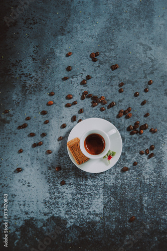 Wallpaper Mural Espresso coffee cup with cake on the white plate. Espresso coffee beans as decoration on the textured background.
 Torontodigital.ca