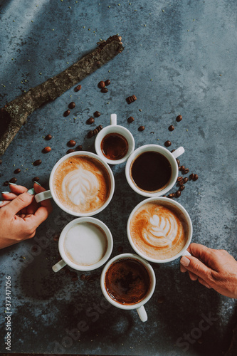 Wallpaper Mural Hands holding fresh cappuccino coffee mugs. Six coffee mugs shot from above.
 Torontodigital.ca