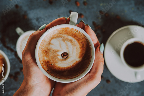 Wallpaper Mural Hands holding fresh cappuccino coffee mug.
 Torontodigital.ca