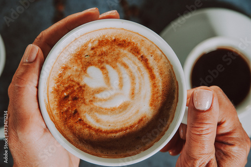 Wallpaper Mural Hands holding fresh cappuccino coffee mug.
 Torontodigital.ca