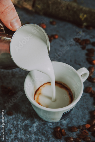 Wallpaper Mural Milk poured into the cappuccino cup. Espresso coffee preparation with milk.
 Torontodigital.ca