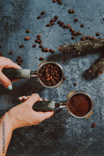 Wallpaper Mural Espresso portafilter . Espresso machine handle full of coffee beans and ground coffee. Two hands holding espresso handles.
 Torontodigital.ca
