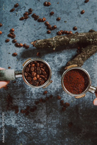 Wallpaper Mural Espresso portafilter . Espresso machine handle full of coffee beans and ground coffee. Two hands holding espresso handles.
 Torontodigital.ca