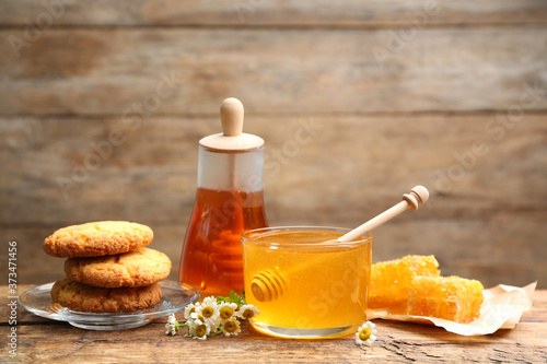 Composition with tasty honey on wooden table
