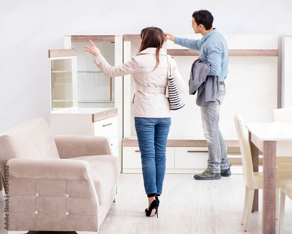 Married couple in the shop choosing furniture Married couple in the shop choosing furniture