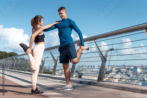 Man and woman making sport training outdoors together