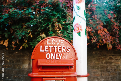 Canvas Print A rustic red painted folky English letterbox with the words 'love letters only'