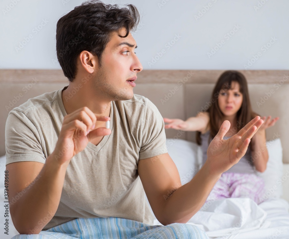 Man suffering from impotency with pill Man suffering from impotency with pill
