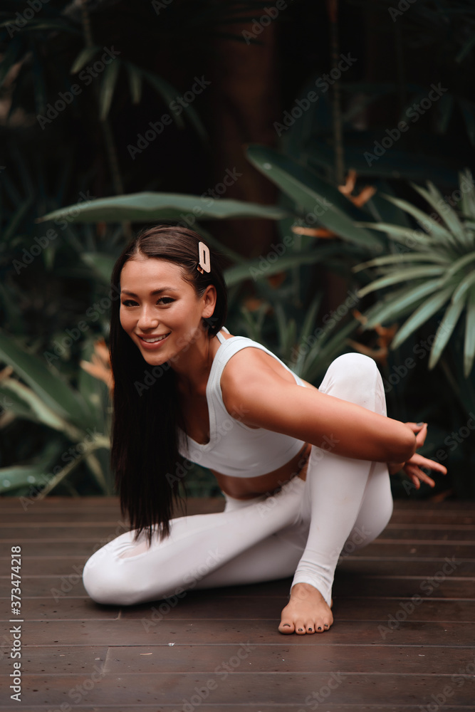 Asian Yoga instructor, in outdoor exercise. Portrait of gorgeous asian young woman practicing yoga outdoor