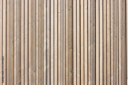 Brown wood wall. Wooden desk background. Straight lines wooden panels. Natural rustic hardwood board texture.