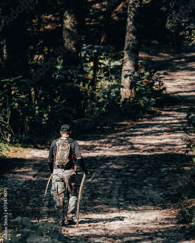 Lonely Mexican white man walking through the mountains with poles and climbing gear. Explorer hiking on a cold sunny morning in Mexico. 