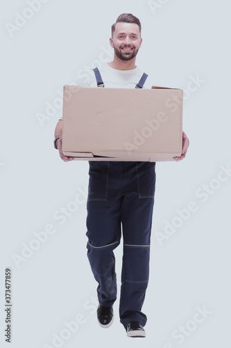 in full growth. smiling man carries a large cardboard box © ASDF