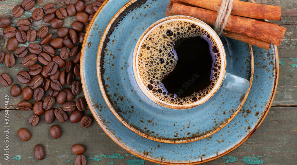 Blue coffee Cup and coffee beans on an old wooden background, top view